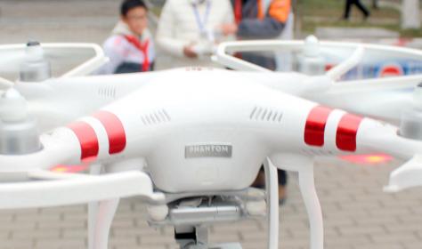 A Chinese girl operates an unmanned aerial vehicle (UAV), or drone, in Suzhou city, east China's Jiangsu province