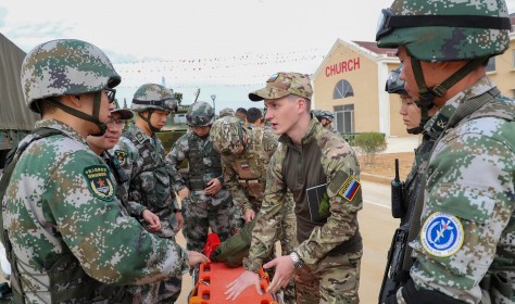 Chinese and Russian soldiers communicate with each other during a joint exercise