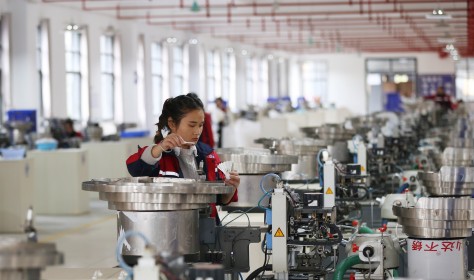 A worker assembles a badminton ball in a production base in Jinping County, Guizhou Province. 