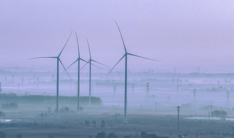 Wind turbines rotate as the sun rises in Zhengji village, Suqian City, Jiangsu Province, China, October 25, 2023.