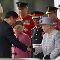 Chinese President Xi Jinping, left, shakes hands with Britain's Queen Elizabeth II in London Tuesday, Oct. 20, 2015, on the first day of their state visit to the United Kingdom. 